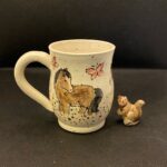 painted pottery mug with horses